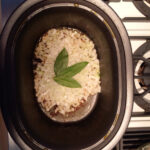 Toss the chopped (minced?) onions and bay leaves into a skillet (of range-safe slow cooker pot.)