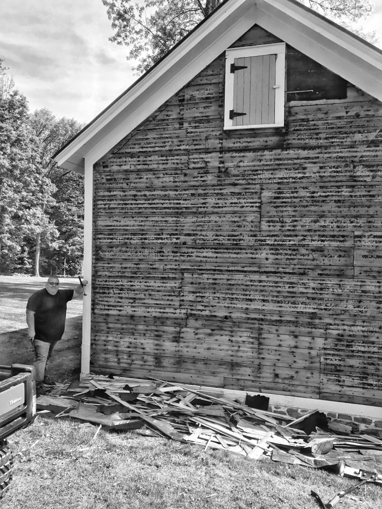 Justin finishing up siding demo on west facade (Source: Hroth Ottosen)