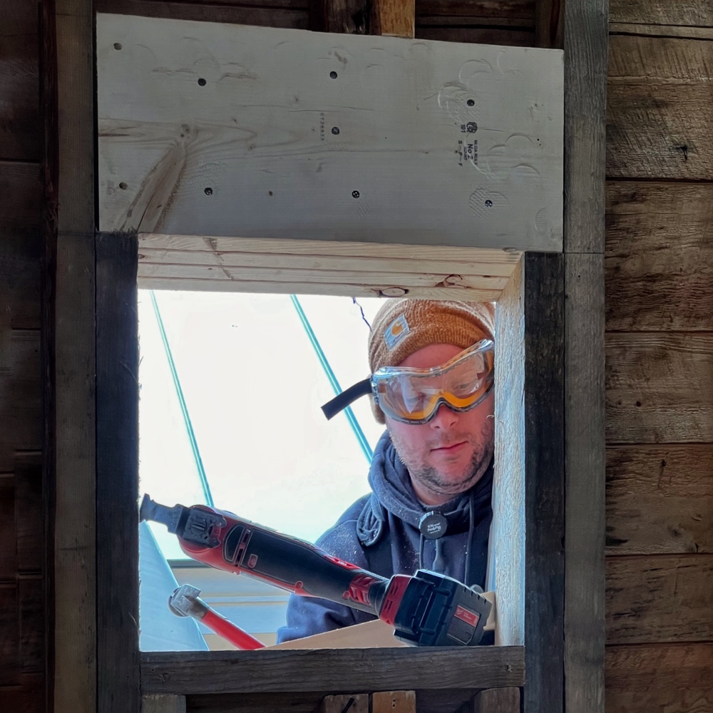 Icehouse Apertures and Transparency: Matt cutting out sheafing from new window (Photo: R.P. Murphy)