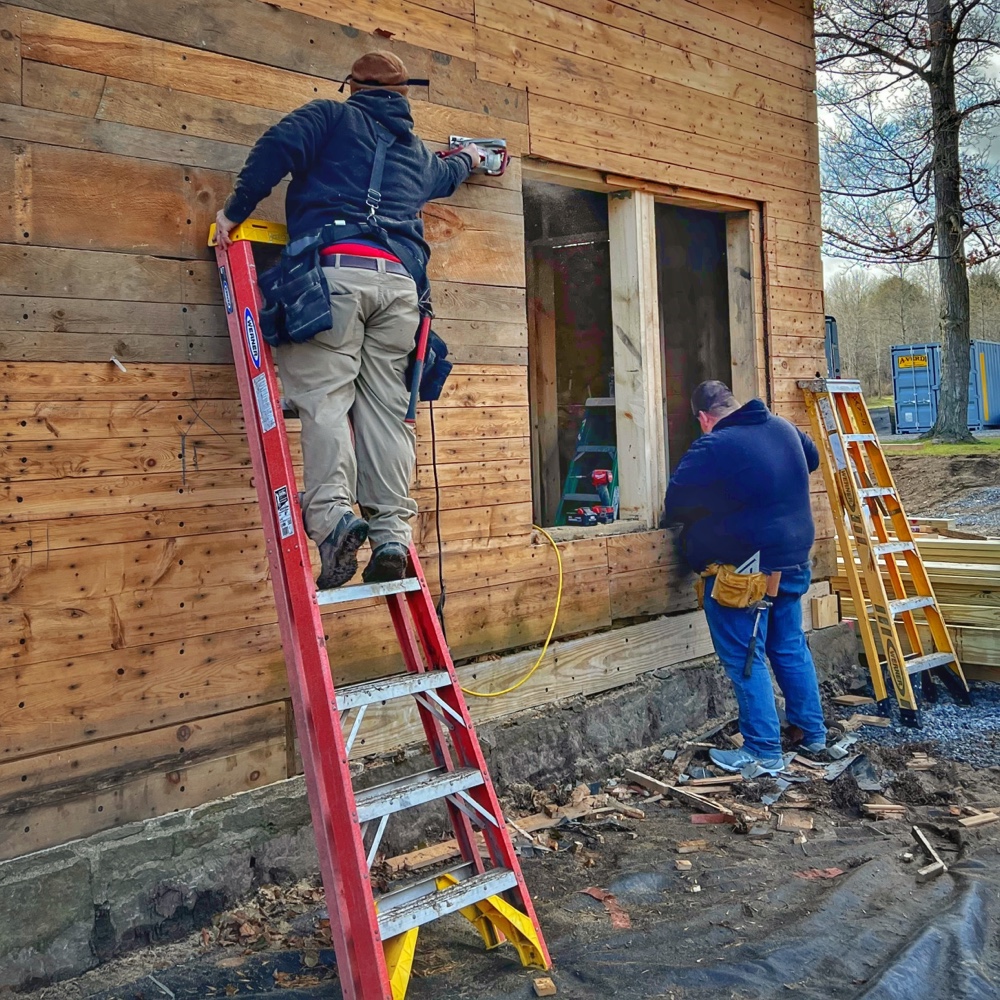 Icehouse Apertures and Transparency: Matt and Justin opening up the new double hung windows (Photo: R.P. Murphy)