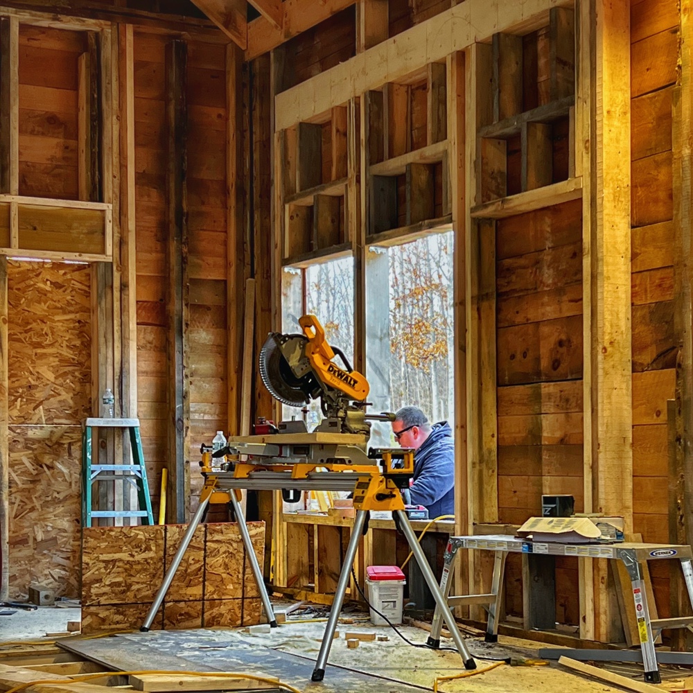 Icehouse Apertures and Transparency: Justin tuning up double hung window framing (Photo: R.P. Murphy)