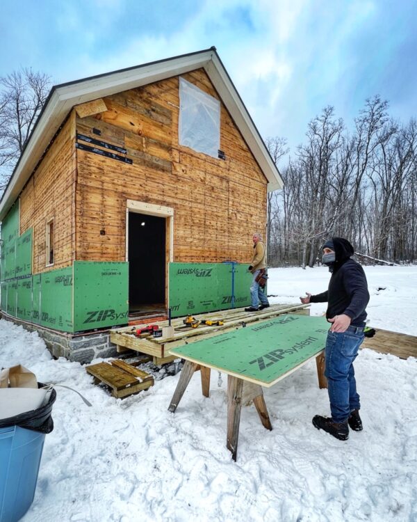 Tony and Hroth installing ZIP System insulated panels on east and south elevations of icehouse (Photo: R.P. Murphy)