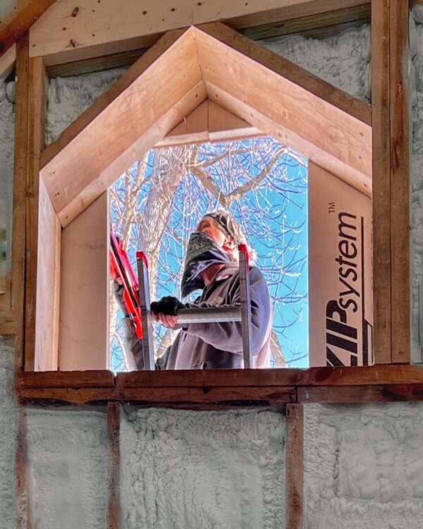 Hroth puts the finishing touches on the ZIP System installation. All four elevations of icehouse are now weathered in! (Photo: R.P. Murphy)