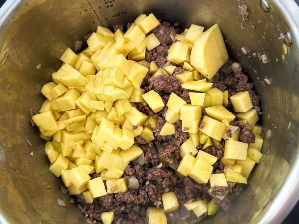 Add Chopped Potatoes to Elk Green Chile Stew (Photo: Geo Davis)