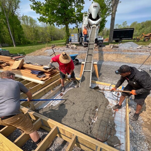 Supi, Calvin, and Tony Pull Concrete for Hot Tub Slab (Photo: R.P. Murphy)