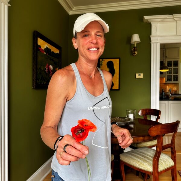 Pam Offering the First Poppies of Summer (Photo: Geo Davis)