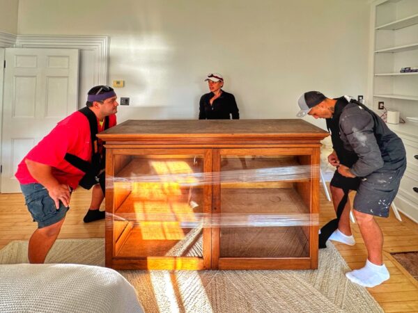 Supi, Pam, and Tony Moving Cherry Cabinet (Photo: Geo Davis)