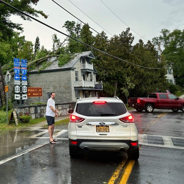 Essex Supervisor Ken Hughes directing traffic in front of storm damaged library (Photo: Geo Davis)