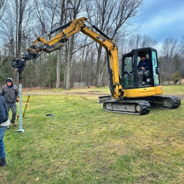 Bob and Phil Installing Helical Piles (Photo: Geo Davis)