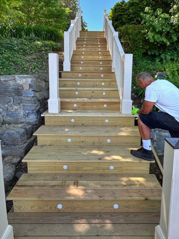 Tony Foster Installing Posts and Railings for Lakeside Staircase (Photo: Glen Gherkins)